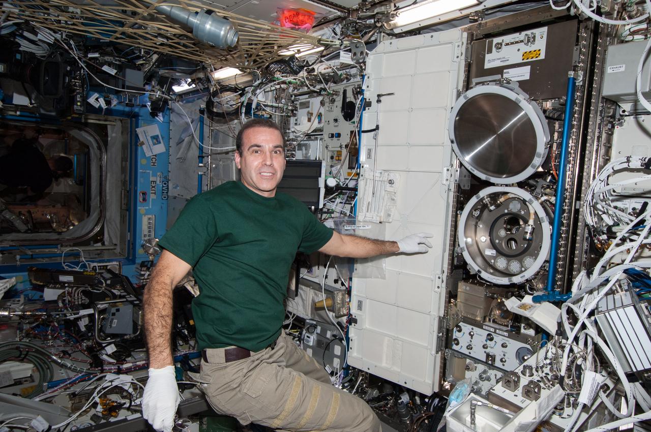 ss038e008298 (11/26/2013) --- A view of NASA astronaut Rick Mastracchio, during the Material Science Laboratory (MSL) Solidification and Quench Furnace (SQF) Sample Cartridge Exchange aboard the International Space Station (ISS). The Materials Science Laboratory (MSL) is used for basic materials research in the microgravity environment of the ISS. The MSL can accommodate and support diverse Experiment Modules. In this way many material types, such as metals, alloys, polymers, semiconductors, ceramics, crystals, and glasses, can be studied to discover new applications for existing materials and new or improved materials.