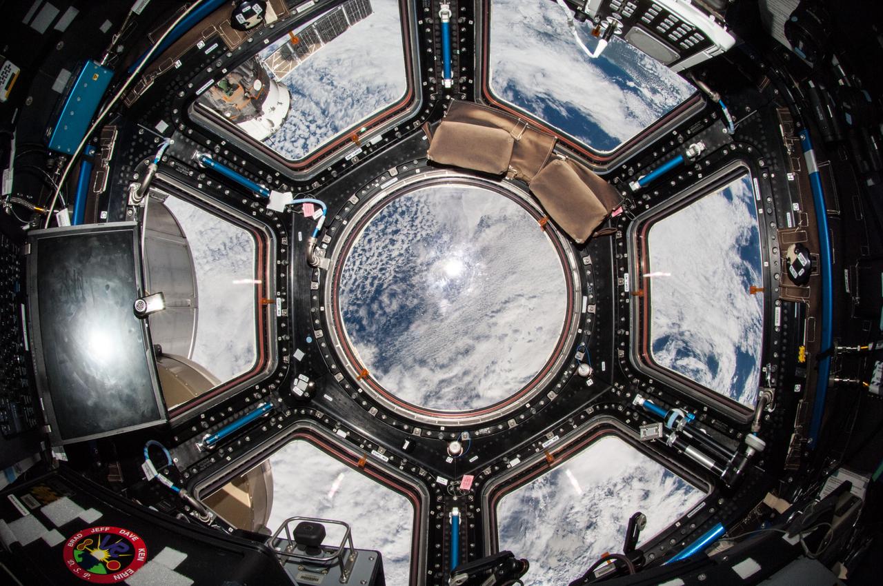 iss038e013587 (12/8/2013) --- A view of the Cupola module aboard the International Space Station (ISS). The cupola is a small module designed for the observation of operations outside the station such as robotic activities, the approach of vehicles, and spacewalks. Its six side windows and a direct nadir viewing window provide spectacular views of Earth and celestial objects. The windows are equipped with shutters to protect them from contamination and collisions with orbital debris or micrometeorites. The cupola house the robotic workstation that controls the Canadarm2.