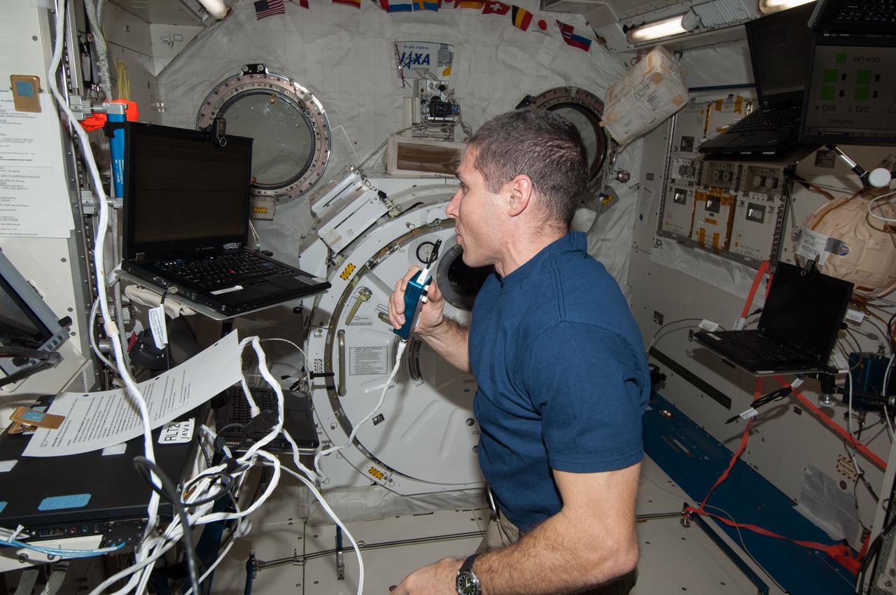 ISS038-E-013670 (8 Dec. 2013) --- NASA astronaut Michael Hopkins, Expedition 38 flight engineer, speaks in a microphone while working in the Kibo laboratory of the International Space Station.