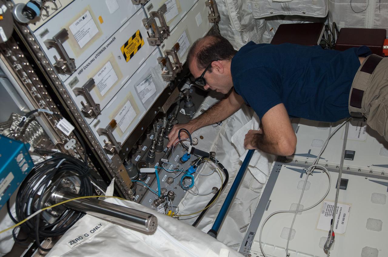 ISS038-E-013718 (9 Dec. 2013) --- NASA astronaut Rick Mastracchio, Expedition 38 flight engineer, performs routine in-flight maintenance in the Columbus laboratory of the International Space Station.