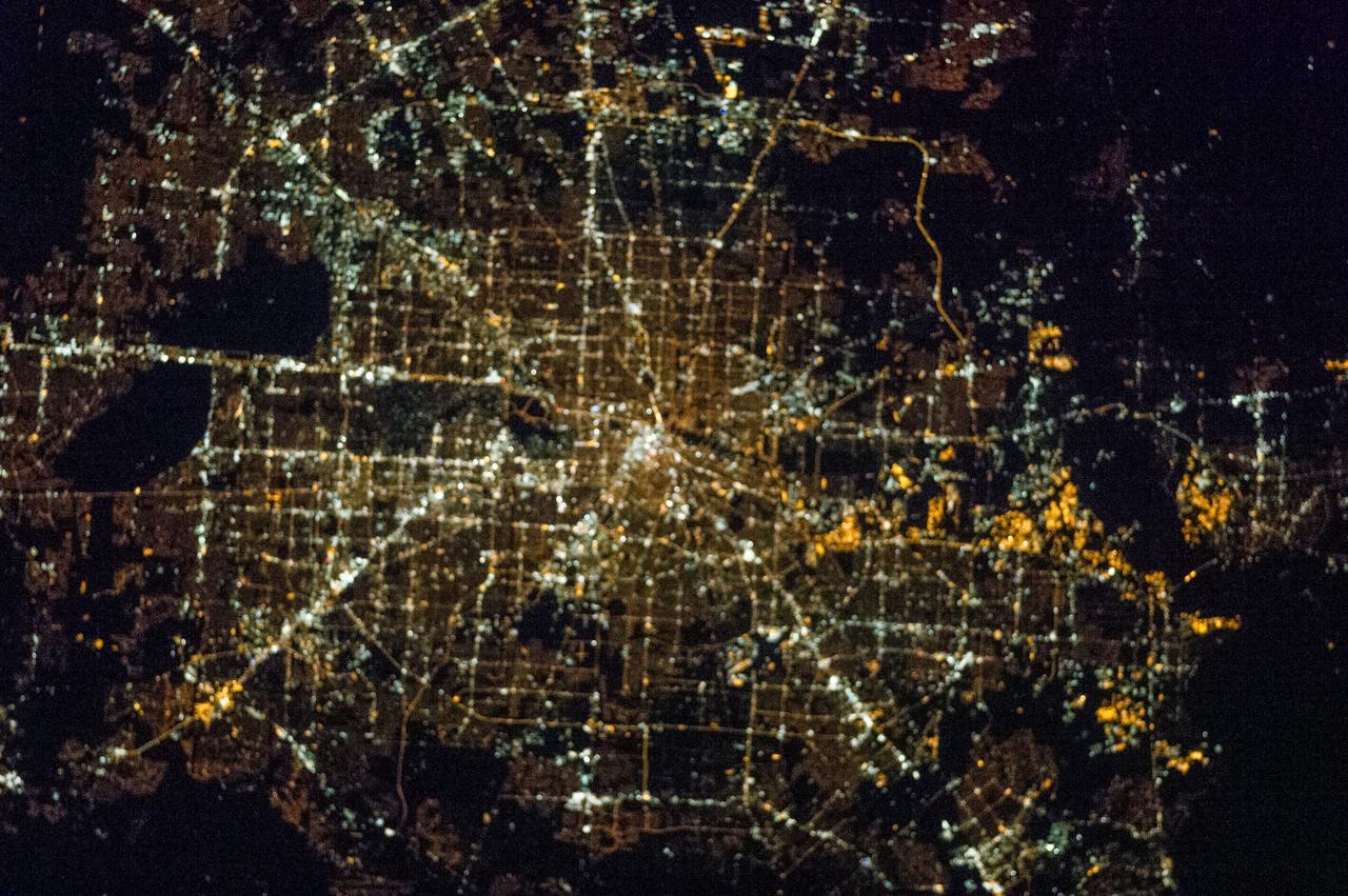 ISS038-E-015162 (12 Dec. 2013) --- One of the Expedition 38 crew members took this brightly lit night picture featuring much of the Houston metropolitan area. The central business district is in the exact center of the photo, with the Galleria area and uptown being in the lower left with Sugar Land being closer to the lower left corner. The 610 Loop and Beltway 8 encircle the city. The southeast sections extend past Hobby Airport to the NASA/Clear Lake area.