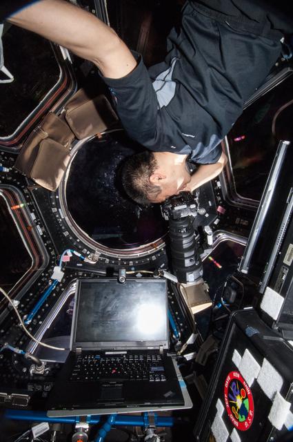 NASA image: Wakata using still camera in the Cupola Module