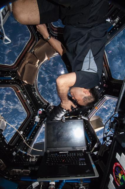 NASA image: Wakata using still camera in the Cupola Module