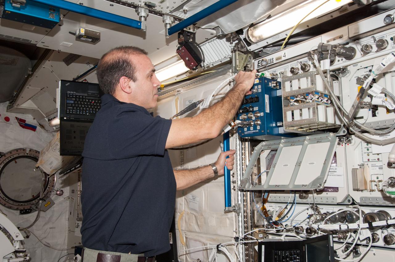 ISS038-E-024791 (2 Jan. 2014) --- In the International Space Station's Kibo laboratory, NASA astronaut Rick Mastracchio, Expedition 38 flight engineer, performs troubleshooting on the Biorack centrifuge for NanoRacks, a facility that provides lower-cost microgravity research facilities for small payloads utilizing a standardized "plug-and-play" interface. Mastracchio checked the three settings of the centrifuge, which is designed to simulate the gravity of Earth, the moon and Mars.