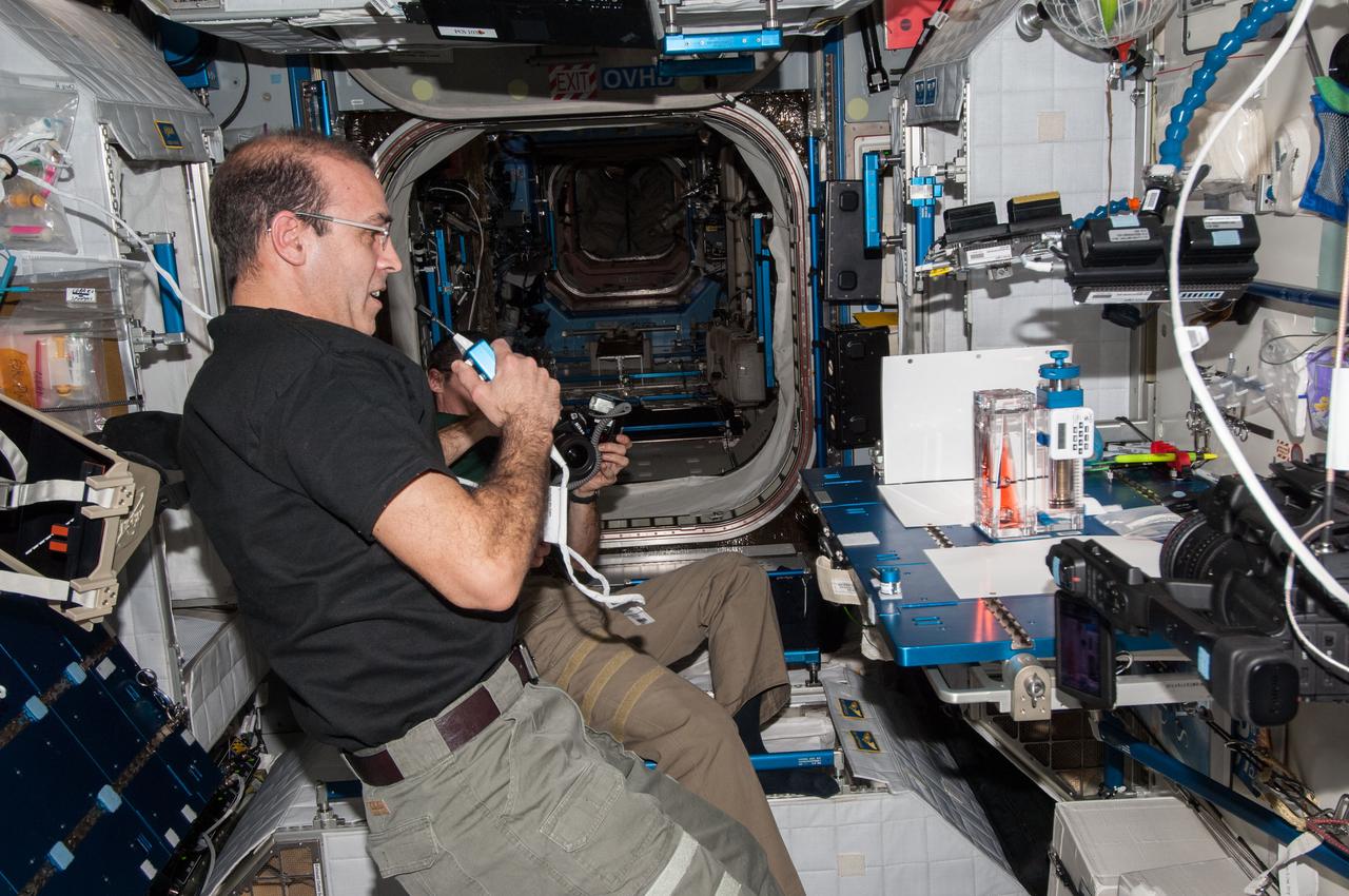 ISS038-E-025000 (3 Jan. 2014) --- NASA astronaut Rick Mastracchio, Expedition 38 flight engineer, speaks in a microphone while conducting a session with the Capillary Flow Experiment (CFE-2) in the Harmony node of the International Space Station. CFE is a suite of fluid physics experiments that investigate how fluids behave in microgravity which could benefit water and fuel delivery systems on future spacecraft. Scientists designed the CFE-2 to study properties of fluids and bubbles inside containers with a specific 3-D geometry.