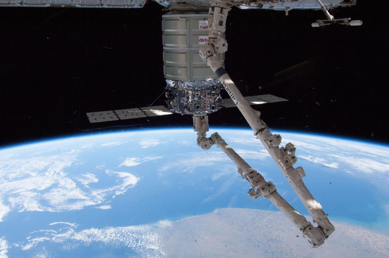 ISS038-E-027333 (12 Jan. 2014) --- The Canadarm2 berths the Orbital Sciences Corp. Cygnus commercial cargo craft to the Harmony node of the International Space Station on Jan. 12, 2014. Earth's horizon and the blackness of space provide the backdrop for the scene.