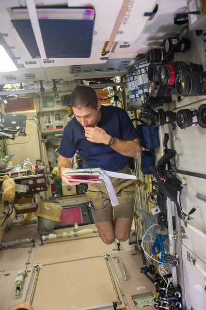 NASA image: Hopkins reads manual in the SM