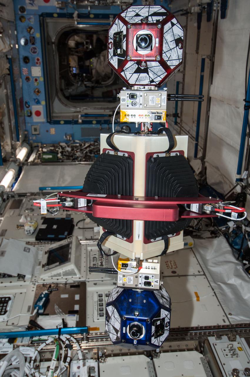 ISS038-E-033888 (22 Jan. 2014) --- A new experiment using the soccer-ball-sized, free-flying satellites known as Synchronized Position Hold, Engage, Reorient, Experimental Satellites, or SPHERES, already on the station, is featured in this image photographed by an Expedition 38 crew member in the International Space Station's Kibo laboratory. For the SPHERES-Slosh experiment, two SPHERES robots are attached to opposite ends of a metal frame holding a plastic tank with green-colored water. The new hardware for the SPHERES-Slosh study was delivered to the station aboard Orbital Sciences' Cygnus cargo craft on Jan. 12.