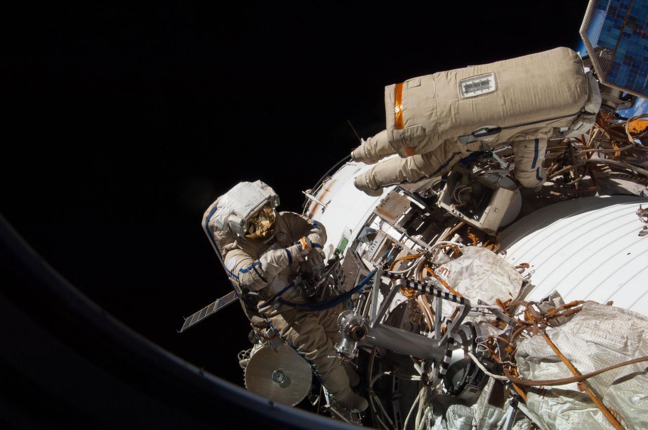 ISS038-E-036126 (27 Jan. 2014) --- Russian cosmonauts Oleg Kotov (right), Expedition 38 commander, and Sergey Ryazanskiy, flight engineer, attired in Russian Orlan spacesuits, participate in a session of extravehicular activity (EVA) in support of assembly and maintenance on the International Space Station. During the six-hour, eight-minute spacewalk, Kotov and Ryazanskiy completed the installation of a pair of high fidelity cameras that experienced connectivity issues during the Dec. 27 spacewalk, and retrieved scientific gear outside the station's Russian segment.