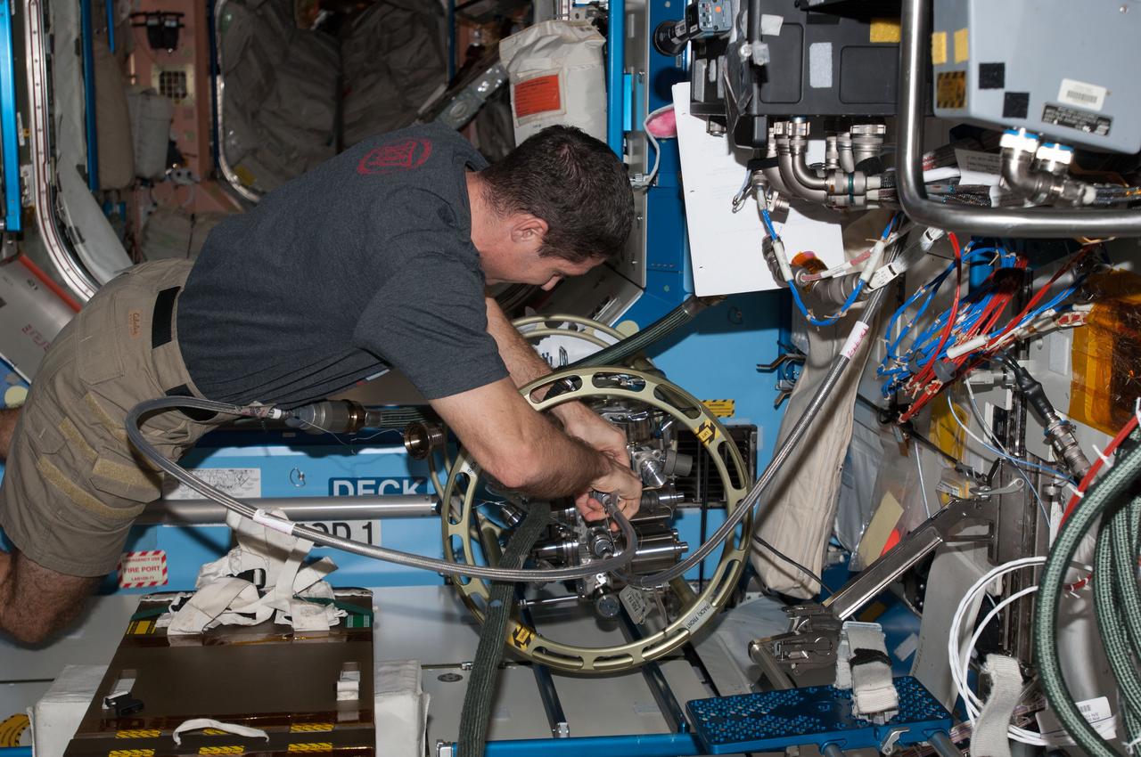 ISS038-E-040139 (31 Jan. 2014) --- NASA astronaut Mike Hopkins, Expedition 38 flight engineer, uses the Fluid Servicing System (FSS) to refill Internal Thermal Control System (ITCS) loops with fresh coolant in the Destiny laboratory of the International Space Station.