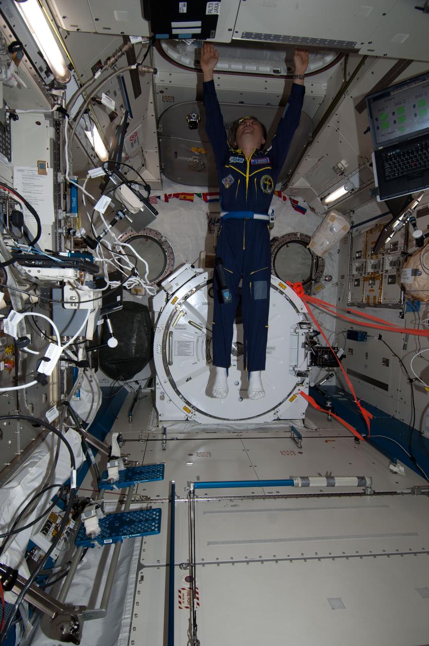 ISS038-E-041429 (4 Feb. 2014) --- Japan Aerospace Exploration Agency astronaut Koichi Wakata, Expedition 38 flight engineer, floats into the Experiment Logistics Modules-Pressurized Section (ELM-PS) of the International Space Station's Kibo laboratory during an in-flight event with his alma mater, Kyushu University in Japan and officials from the Fukuoka Prefecture.