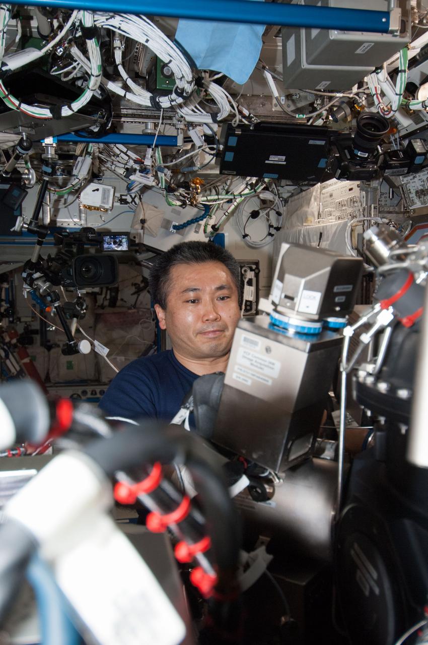ISS038-E-042758 (5 Feb. 2014) --- Japan Aerospace Exploration Agency astronaut Koichi Wakata, Expedition 38 flight engineer, works on the Combustion Integrated Rack (CIR) in the Destiny laboratory of the International Space Station. This research rack, which includes an optics bench, combustion chamber, fuel and oxidizer control and five different cameras, allows a variety of combustion experiments to be performed safely aboard the station.
