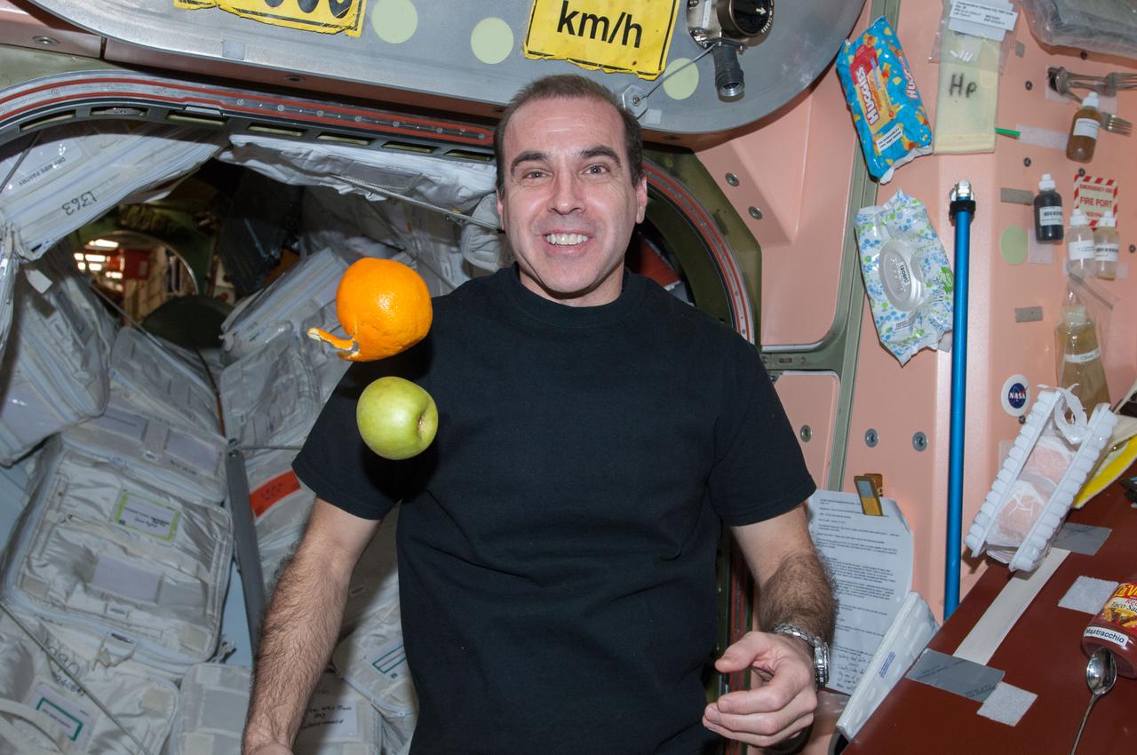 ISS038-E-043011 (6 Feb. 2014) --- NASA astronaut Rick Mastracchio, Expedition 38 flight engineer, is pictured near fresh fruit floating freely in the Unity node of the International Space Station. The fruit was brought to the station on the ISS Progress 54 cargo spacecraft, which docked Feb. 5, 2014.