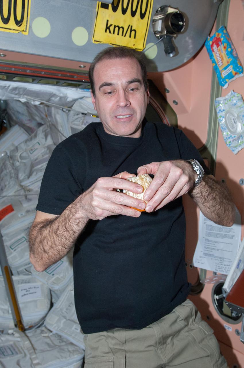 ISS038-E-043015 (6 Feb. 2014) --- NASA astronaut Rick Mastracchio, Expedition 38 flight engineer, prepares to eat a fresh orange in the Unity node of the International Space Station. The fruit was brought to the station on the ISS Progress 54 cargo spacecraft, which docked Feb. 5, 2014.