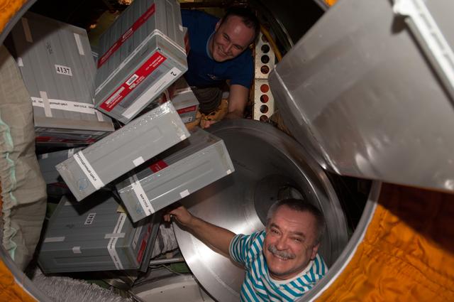 NASA image: Tyurin and Ryazanskiy unpacks Storage Containers