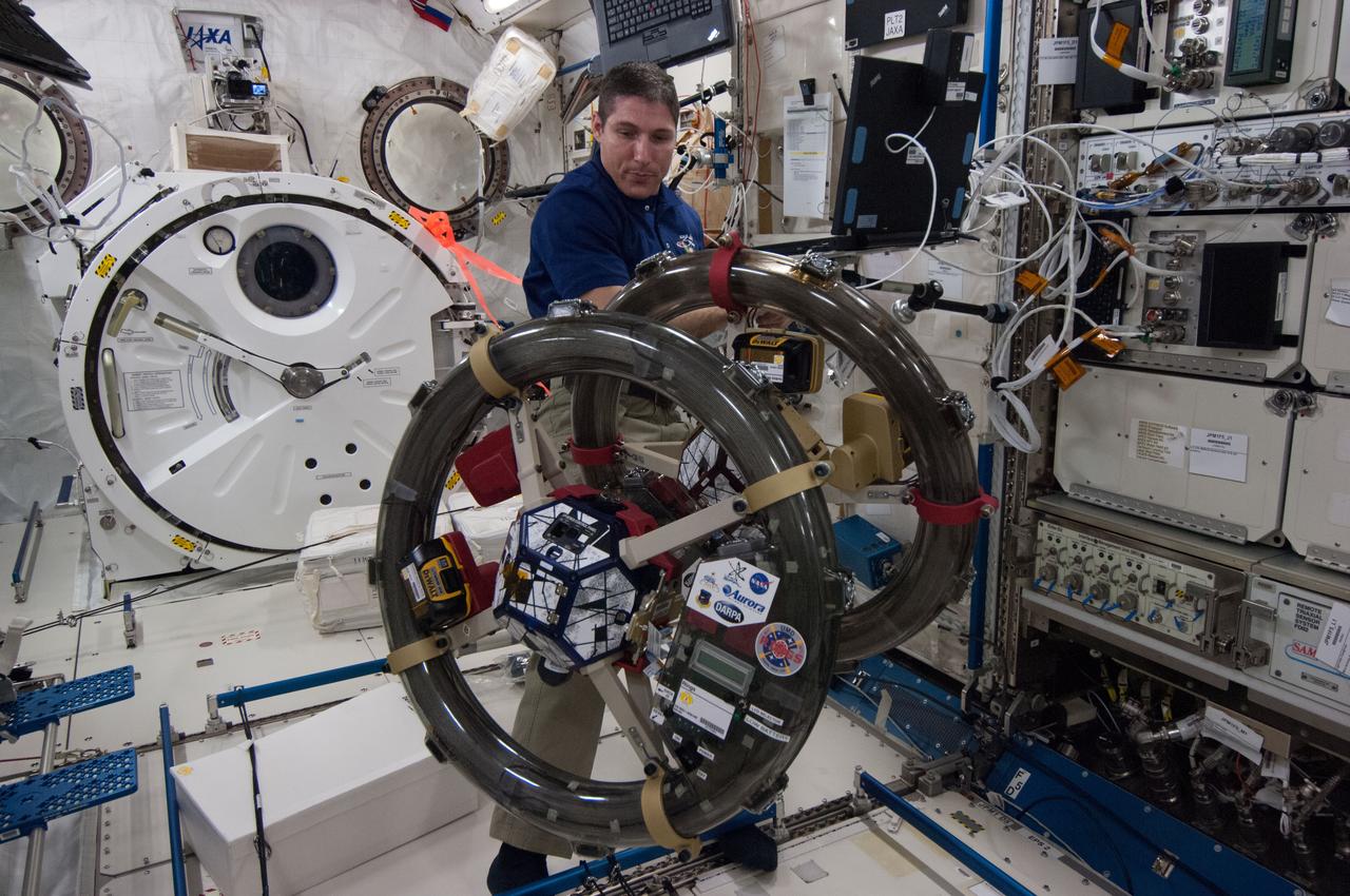 ISS038-E-045620 (10 Feb. 2014) --- NASA astronaut Mike Hopkins, Expedition 38 flight engineer, works with the Synchronized Position, Hold, Engage, Reorient, Experimental Satellites-Resonant Inductive Near-field Generation System (SPHERES-RINGS) experiment gear in the Kibo laboratory of the International Space Station.