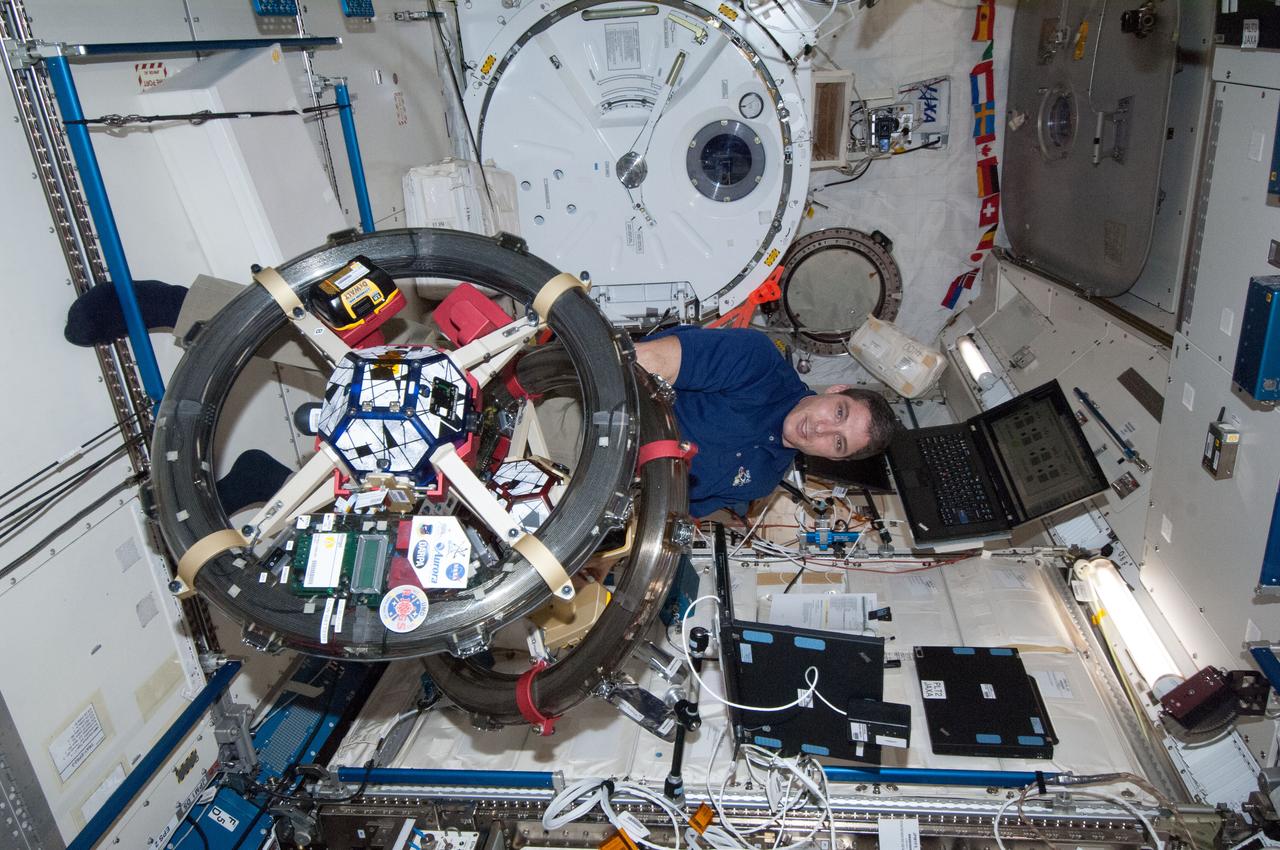 ISS038-E-045622 (10 Feb. 2014) --- NASA astronaut Mike Hopkins, Expedition 38 flight engineer, works with the Synchronized Position, Hold, Engage, Reorient, Experimental Satellites-Resonant Inductive Near-field Generation System (SPHERES-RINGS) experiment gear in the Kibo laboratory of the International Space Station.