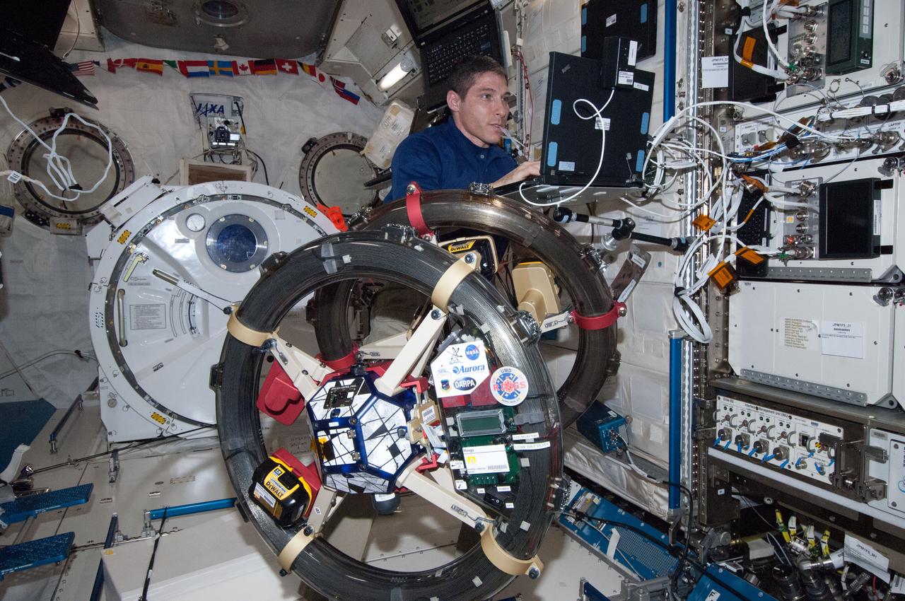 ISS038-E-045623 (10 Feb. 2014) --- NASA astronaut Mike Hopkins, Expedition 38 flight engineer, works with the Synchronized Position, Hold, Engage, Reorient, Experimental Satellites-Resonant Inductive Near-field Generation System (SPHERES-RINGS) experiment gear in the Kibo laboratory of the International Space Station.