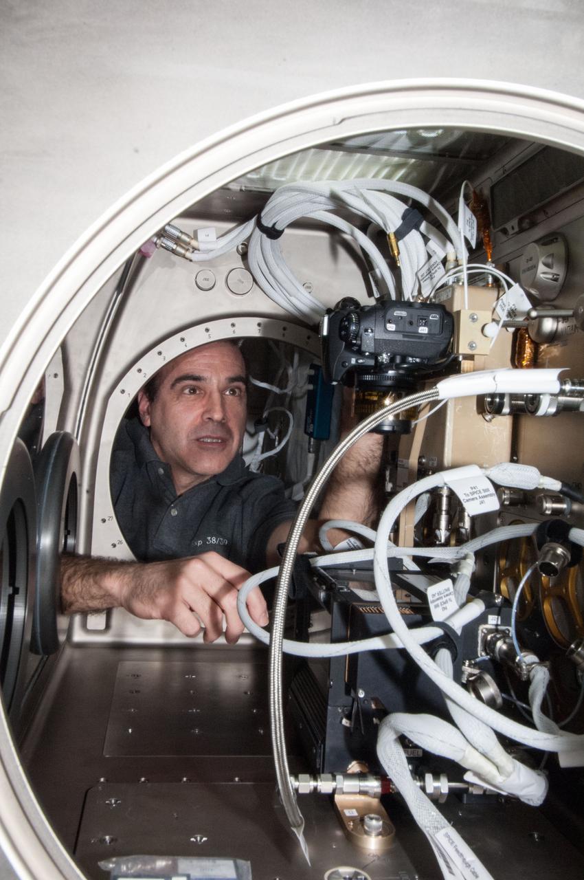 ISS038-E-046391 (12 Feb. 2014) --- NASA astronaut Rick Mastracchio, Expedition 38 flight engineer, sets up the Microgravity Science Glovebox (MSG) for the Burning and Suppression of Solids (BASS-II) experiment in the Destiny laboratory of the International Space Station. BASS-II explores how different substances burn in microgravity with benefits for combustion on Earth and fire safety in space.