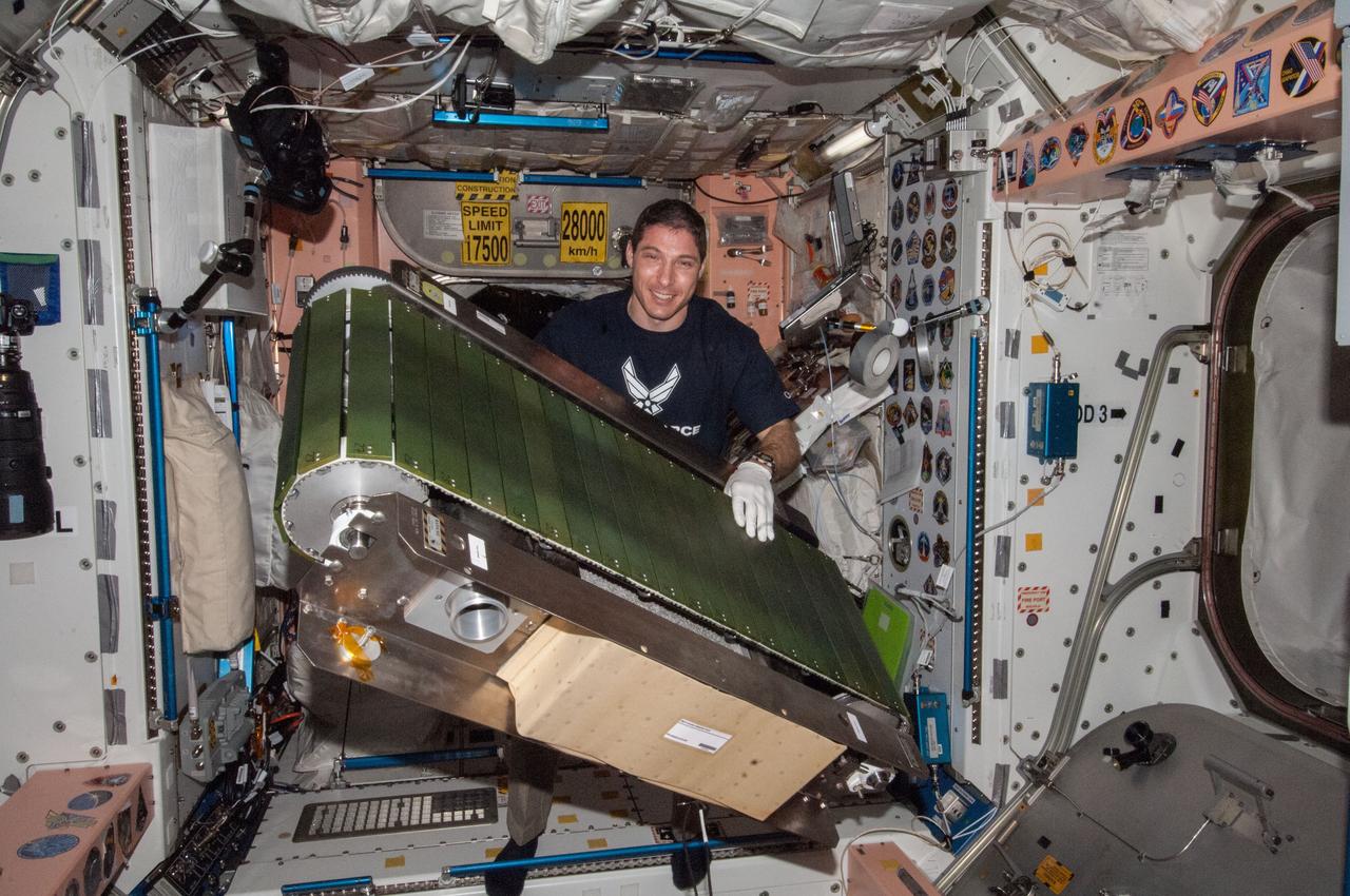 ISS038-E-046401 (12 Feb. 2014) --- NASA astronaut Mike Hopkins, Expedition 38 flight engineer, works on the COLBERT treadmill in the Unity node of the International Space Station. He replaced a failed accelerometer in the exercise device then activated COLBERT for a speed test.