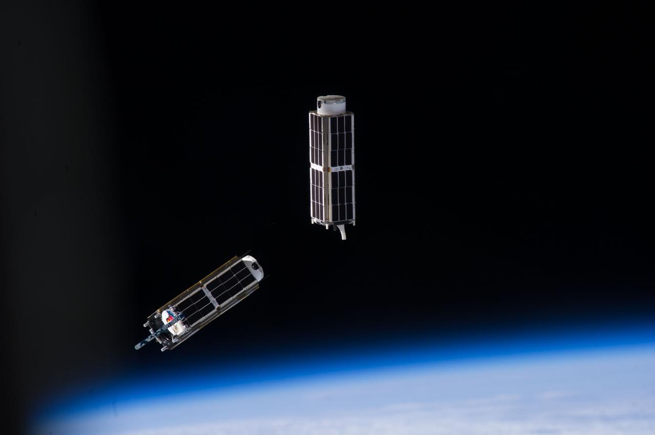 ISS038-E-046586 (13 Feb. 2014) --- A set of NanoRacks CubeSats is photographed by an Expedition 38 crew member after the deployment by the NanoRacks Launcher attached to the end of the Japanese robotic arm. The CubeSats program contains a variety of experiments such as Earth observations and advanced electronics testing.