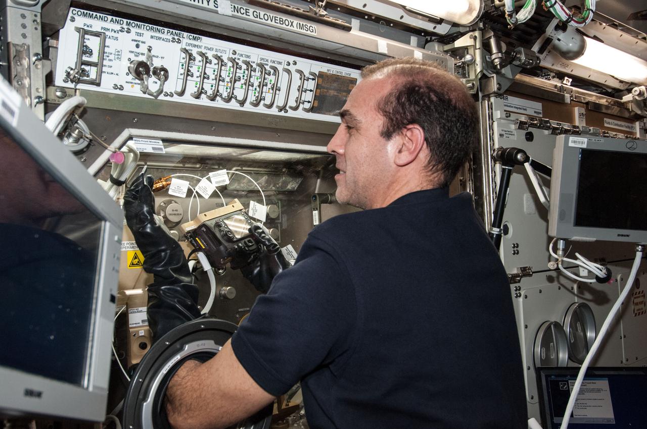 ISS038-E-047576 (14 Feb. 2014) --- NASA astronaut Rick Mastracchio, Expedition 38 flight engineer, works with the Burning and Suppression of Solids (BASS-II) experiment in the Microgravity Science Glovebox (MSG) located in the Destiny laboratory of the International Space Station. BASS-II explores how different substances burn in microgravity with benefits for combustion on Earth and fire safety in space.