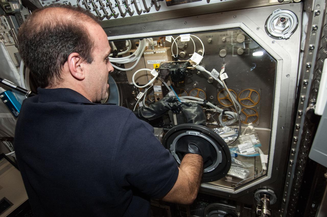 ISS038-E-047582 (14 Feb. 2014) --- NASA astronaut Rick Mastracchio, Expedition 38 flight engineer, works with the Burning and Suppression of Solids (BASS-II) experiment in the Microgravity Science Glovebox (MSG) located in the Destiny laboratory of the International Space Station. BASS-II explores how different substances burn in microgravity with benefits for combustion on Earth and fire safety in space.