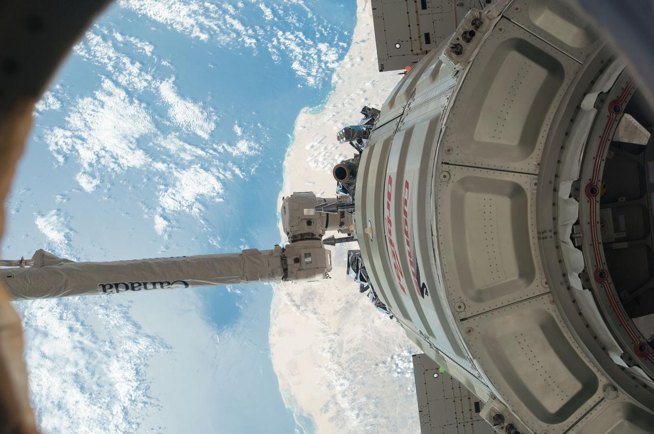 ISS038-E-049421 (18 Feb. 2014) --- The International Space Station's Canadarm2 unberths the Orbital Sciences Corporation's Cygnus spacecraft after several weeks at the space station. NASA astronaut Mike Hopkins, with assistance from Japan Aerospace Exploration Agency astronaut Koichi Wakata, both Expedition 38 flight engineers, used the station's 57-foot Canadarm2 robotic arm to detach Cygnus from the Earth-facing port of the Harmony node at 5:15 a.m. (EST) on Feb. 18, 2014. While Wakata monitored data and kept in contact with the team at Houston's Mission Control Center, Hopkins released Cygnus from the robotic arm at 6:41 a.m.