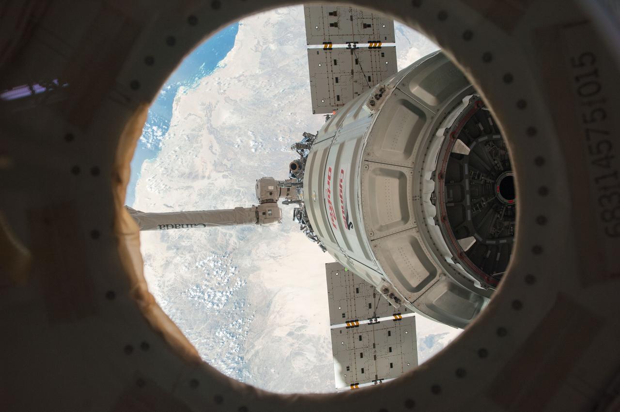 ISS038-E-049423 (18 Feb. 2014) --- The International Space Station's Canadarm2 unberths the Orbital Sciences Corporation's Cygnus spacecraft after several weeks at the space station. NASA astronaut Mike Hopkins, with assistance from Japan Aerospace Exploration Agency astronaut Koichi Wakata, both Expedition 38 flight engineers, used the station's 57-foot Canadarm2 robotic arm to detach Cygnus from the Earth-facing port of the Harmony node at 5:15 a.m. (EST) on Feb. 18, 2014. While Wakata monitored data and kept in contact with the team at Houston's Mission Control Center, Hopkins released Cygnus from the robotic arm at 6:41 a.m.