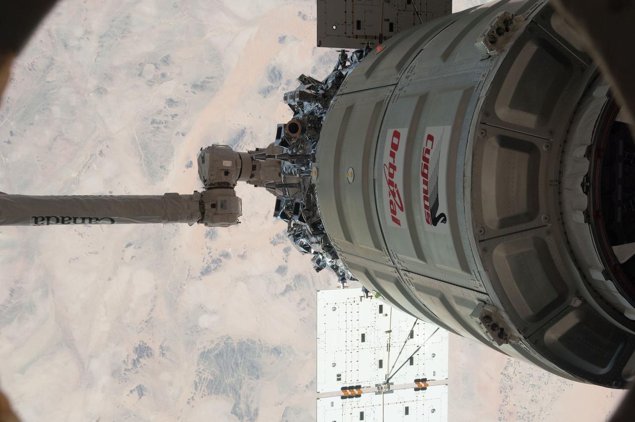 ISS038-E-049430 (18 Feb. 2014) --- The International Space Station's Canadarm2 unberths the Orbital Sciences Corporation's Cygnus spacecraft after several weeks at the space station. NASA astronaut Mike Hopkins, with assistance from Japan Aerospace Exploration Agency astronaut Koichi Wakata, both Expedition 38 flight engineers, used the station's 57-foot Canadarm2 robotic arm to detach Cygnus from the Earth-facing port of the Harmony node at 5:15 a.m. (EST) on Feb. 18, 2014. While Wakata monitored data and kept in contact with the team at Houston's Mission Control Center, Hopkins released Cygnus from the robotic arm at 6:41 a.m.