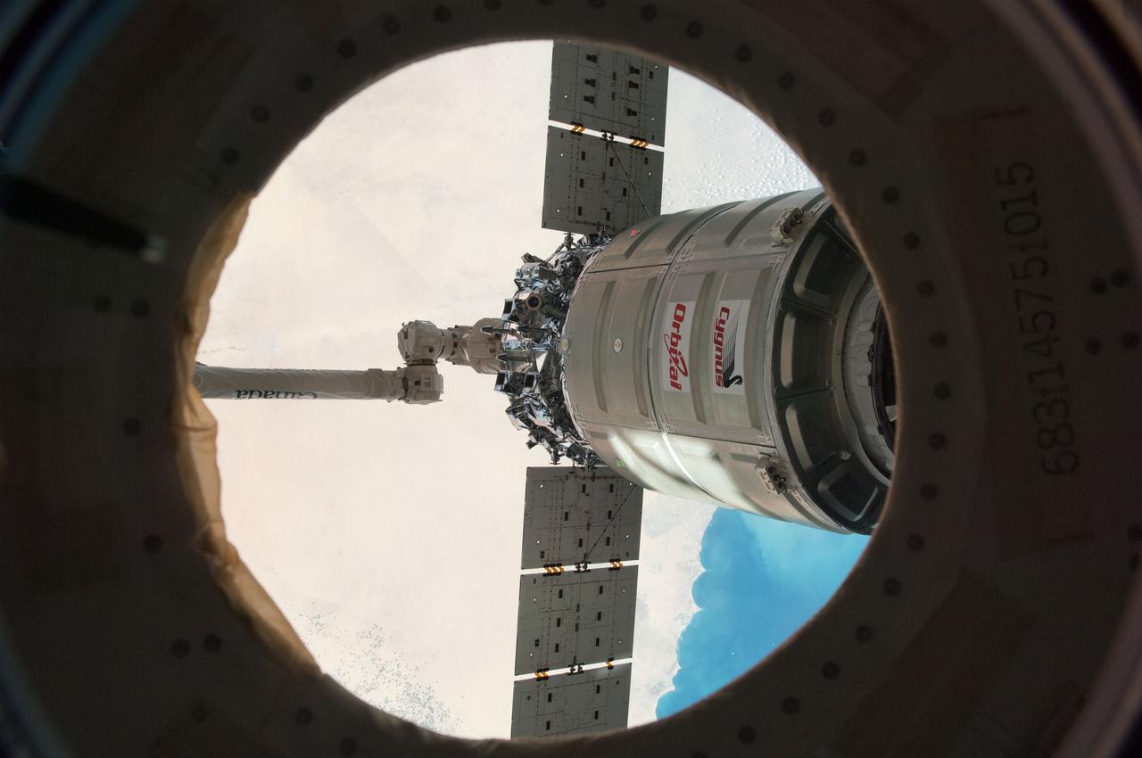 ISS038-E-049438 (18 Feb. 2014) --- The International Space Station's Canadarm2 unberths the Orbital Sciences Corporation's Cygnus spacecraft after several weeks at the space station. NASA astronaut Mike Hopkins, with assistance from Japan Aerospace Exploration Agency astronaut Koichi Wakata, both Expedition 38 flight engineers, used the station's 57-foot Canadarm2 robotic arm to detach Cygnus from the Earth-facing port of the Harmony node at 5:15 a.m. (EST) on Feb. 18, 2014. While Wakata monitored data and kept in contact with the team at Houston's Mission Control Center, Hopkins released Cygnus from the robotic arm at 6:41 a.m.