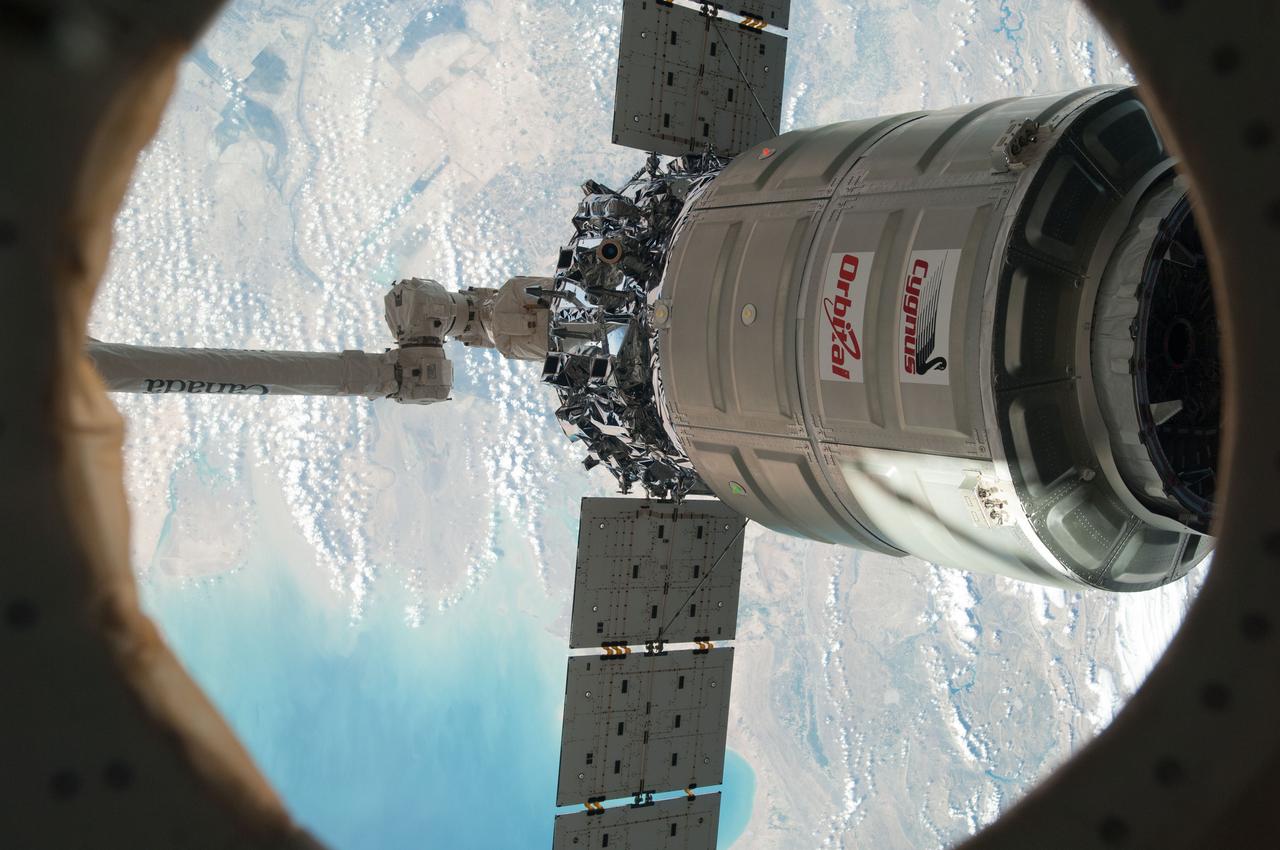 ISS038-E-049445 (18 Feb. 2014) --- The International Space Station's Canadarm2 unberths the Orbital Sciences Corporation's Cygnus spacecraft after several weeks at the space station. NASA astronaut Mike Hopkins, with assistance from Japan Aerospace Exploration Agency astronaut Koichi Wakata, both Expedition 38 flight engineers, used the station's 57-foot Canadarm2 robotic arm to detach Cygnus from the Earth-facing port of the Harmony node at 5:15 a.m. (EST) on Feb. 18, 2014. While Wakata monitored data and kept in contact with the team at Houston's Mission Control Center, Hopkins released Cygnus from the robotic arm at 6:41 a.m.