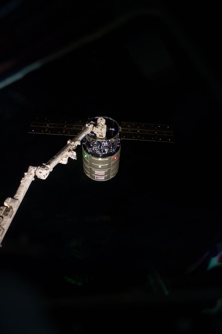 ISS038-E-050049 (18 Feb. 2014) --- The International Space Station's Canadarm2 prepares to release the Orbital Sciences Corporation's Cygnus spacecraft after several weeks at the space station. NASA astronaut Mike Hopkins, with assistance from Japan Aerospace Exploration Agency astronaut Koichi Wakata, both Expedition 38 flight engineers, used the station's 57-foot Canadarm2 robotic arm to detach Cygnus from the Earth-facing port of the Harmony node at 5:15 a.m. (EST) on Feb. 18, 2014. While Wakata monitored data and kept in contact with the team at Houston's Mission Control Center, Hopkins released Cygnus from the robotic arm at 6:41 a.m.