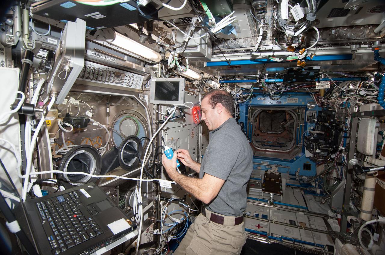 ISS038-E-053250 (18 Feb. 2014) --- NASA astronaut Rick Mastracchio, Expedition 38 flight engineer, works with the Burning and Suppression of Solids (BASS-II) experiment in the Microgravity Science Glovebox (MSG) located in the Destiny laboratory of the International Space Station. BASS-II explores how different substances burn in microgravity with benefits for combustion on Earth and fire safety in space.