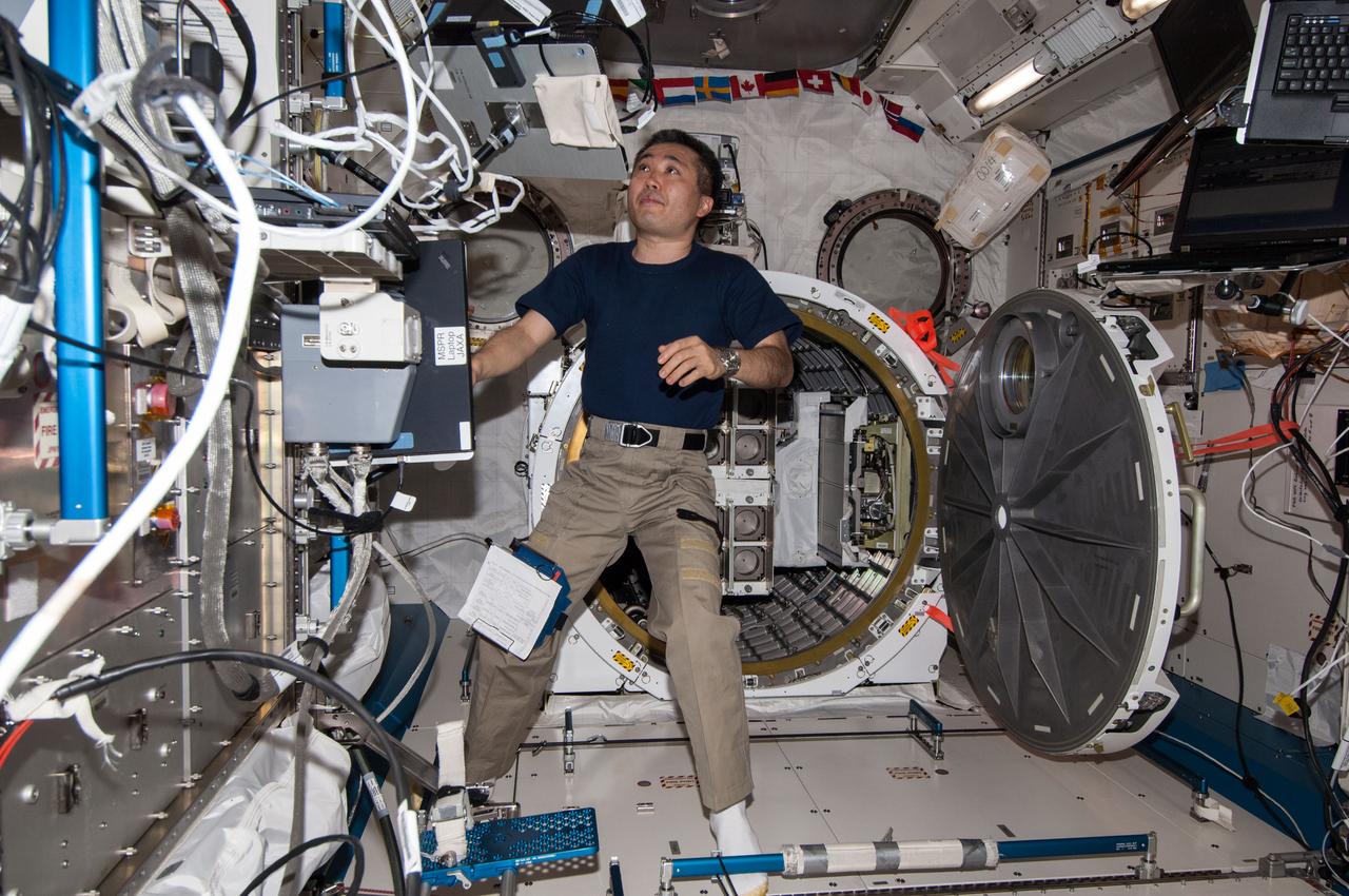 ISS038-E-053257 (19 Feb. 2014) --- In the International Space Station's Kibo laboratory, Japan Aerospace Exploration Agency astronaut Koichi Wakata, Expedition 38 flight engineer, prepares for the deployment of a second batch of NanoRacks CubeSats.