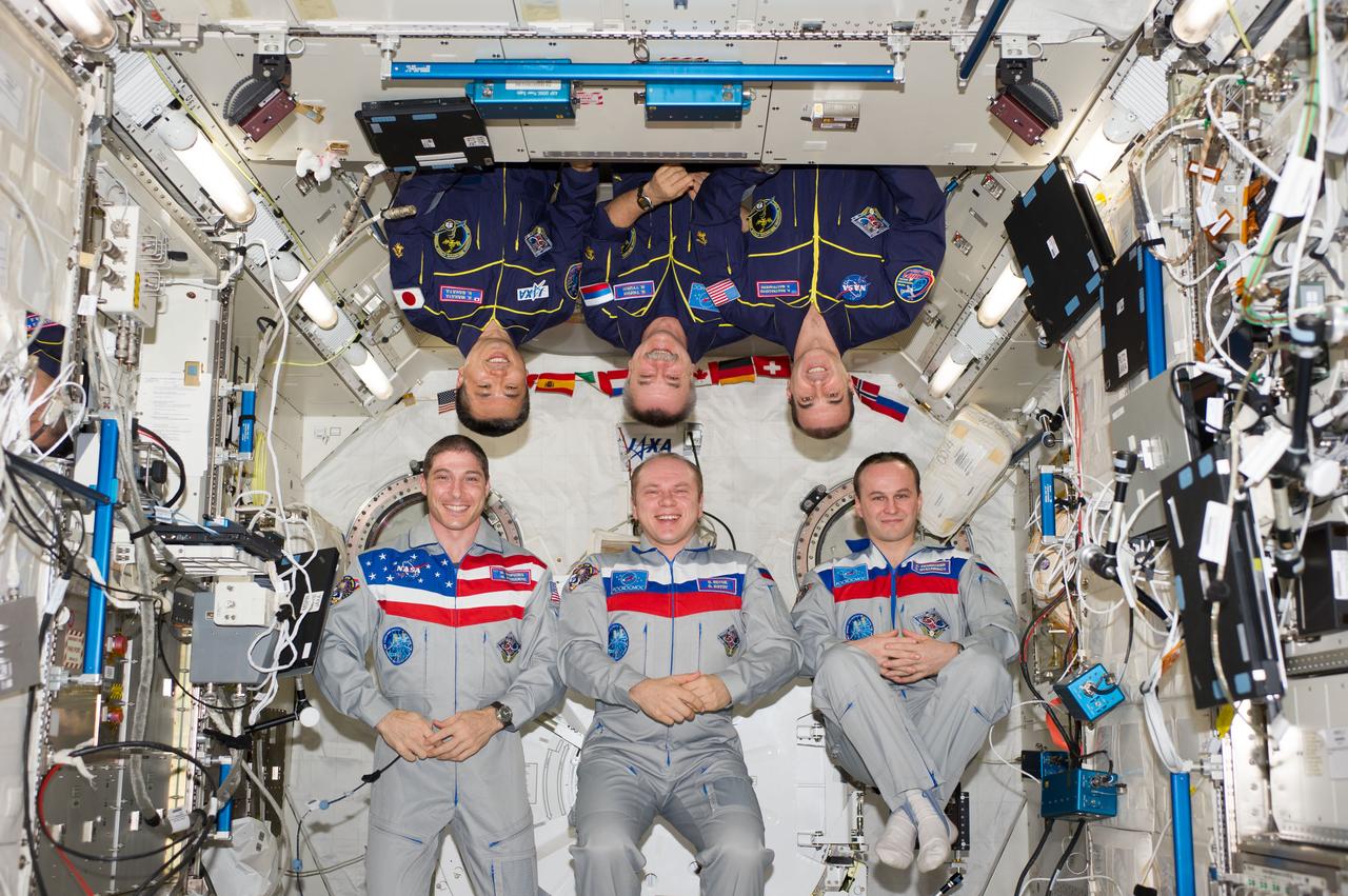 ISS038-E-054963 (22 Feb. 2014) --- Expedition 38 crew members pose for an in-flight crew portrait in the Kibo laboratory of the International Space Station. Pictured on the bottom row are Russian cosmonaut Oleg Kotov (center), commander; NASA astronaut Mike Hopkins (left) and Russian cosmonaut Sergey Ryazanskiy, both flight engineers. Pictured on the top row (from the left) are Japan Aerospace Exploration Agency astronaut Koichi Wakata, Russian cosmonaut Mikhail Tyurin and NASA astronaut Rick Mastracchio, all flight engineers.