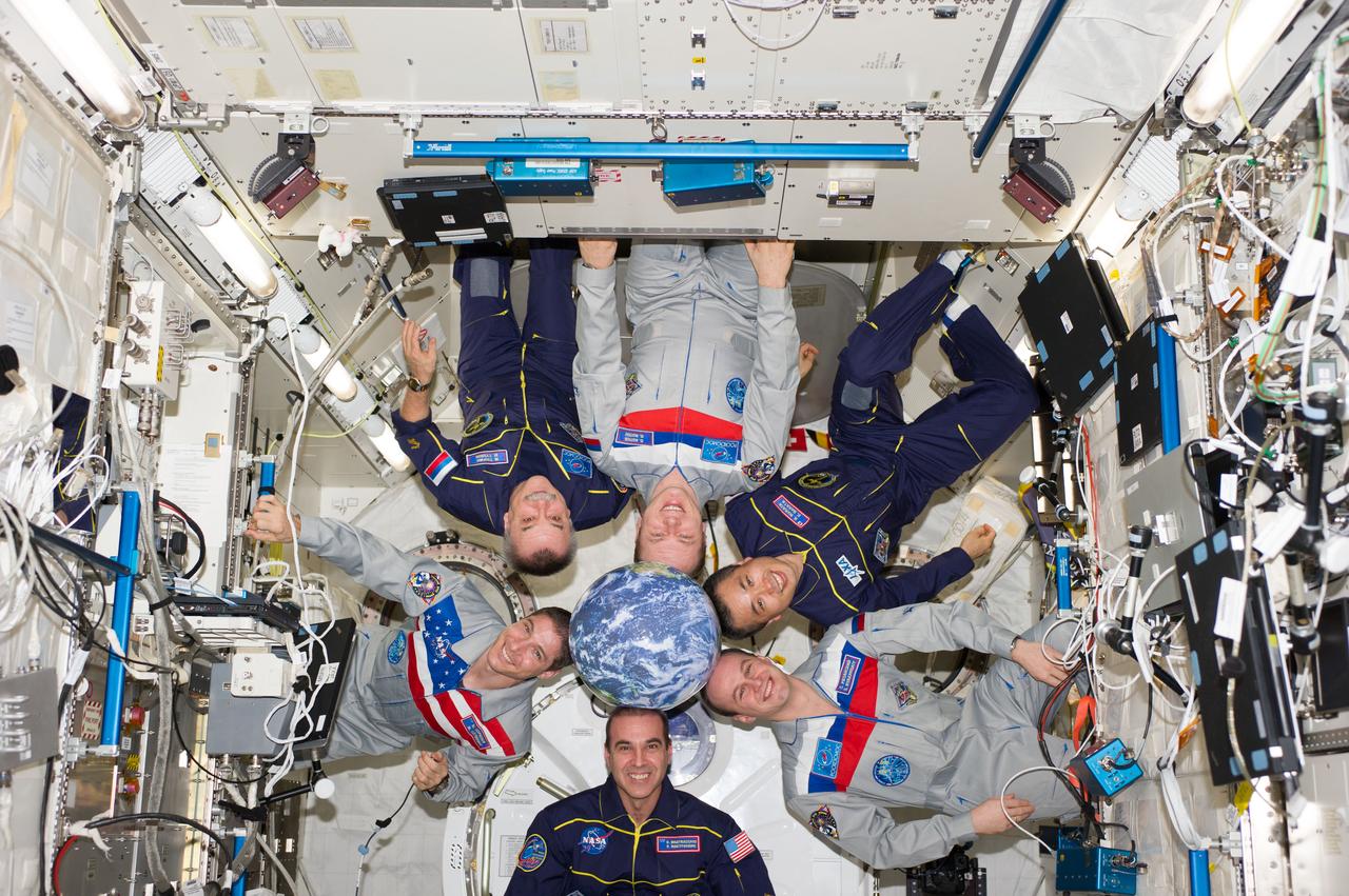 ISS038-E-054970 (22 Feb. 2014) --- Expedition 38 crew members pose for an in-flight crew portrait in the Kibo laboratory of the International Space Station. Pictured (clockwise from top center) are Russian cosmonaut Oleg Kotov, commander; Japan Aerospace Exploration Agency astronaut Koichi Wakata, Russian cosmonaut Sergey Ryazanskiy, NASA astronauts Rick Mastracchio and Mike Hopkins, and Russian cosmonaut Mikhail Tyurin, all flight engineers.