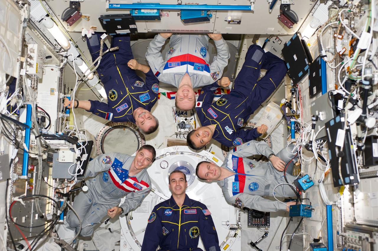 ISS038-E-054979 (22 Feb. 2014) --- Expedition 38 crew members pose for an in-flight crew portrait in the Kibo laboratory of the International Space Station. Pictured (clockwise from top center) are Russian cosmonaut Oleg Kotov, commander; Japan Aerospace Exploration Agency astronaut Koichi Wakata, Russian cosmonaut Sergey Ryazanskiy, NASA astronauts Rick Mastracchio and Mike Hopkins, and Russian cosmonaut Mikhail Tyurin, all flight engineers.