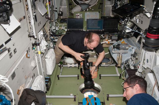 NASA image: Kotov holds 400mm camera lens in the SM