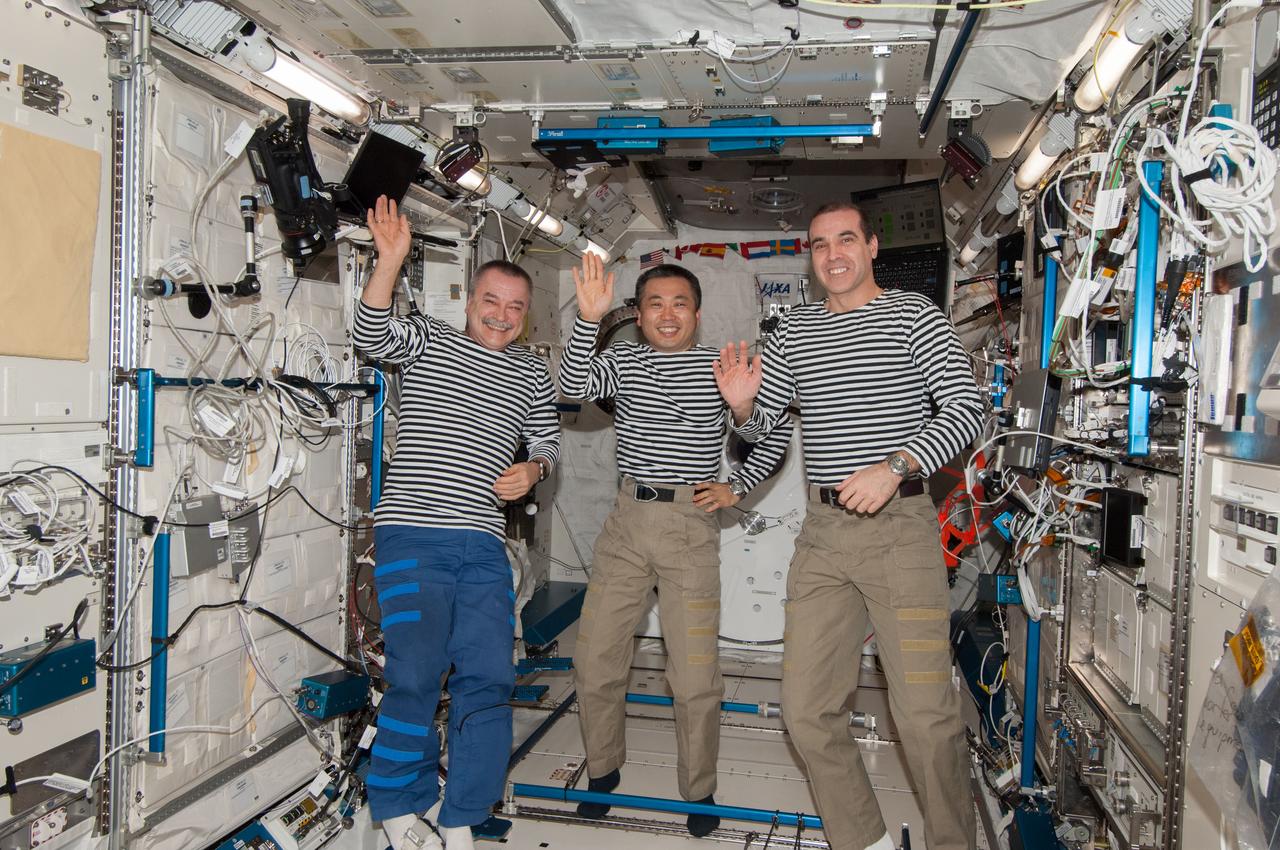 ISS038-E-068903 (9 March 2014) --- The new commander of the current crew on the International Space Station (Expedition 39) and the Expedition 38/39 flight engineers wave inside the Kibo laboratory.  Their waving may very well be a symbolic farewell to the Expedition 38 crew members (out of frame) who are on the eve of their departure day from the orbital outpost. Expedition 39 Commander Koichi Wakata (center) of the Japanese Aerospace Exploration Agency (JAXA) is joined here by Flight Engineers Rick Mastracchio (right) of NASA and cosmonaut Mikhail Tyurin of the Russian Federal Space Agency (Roscosmos).
