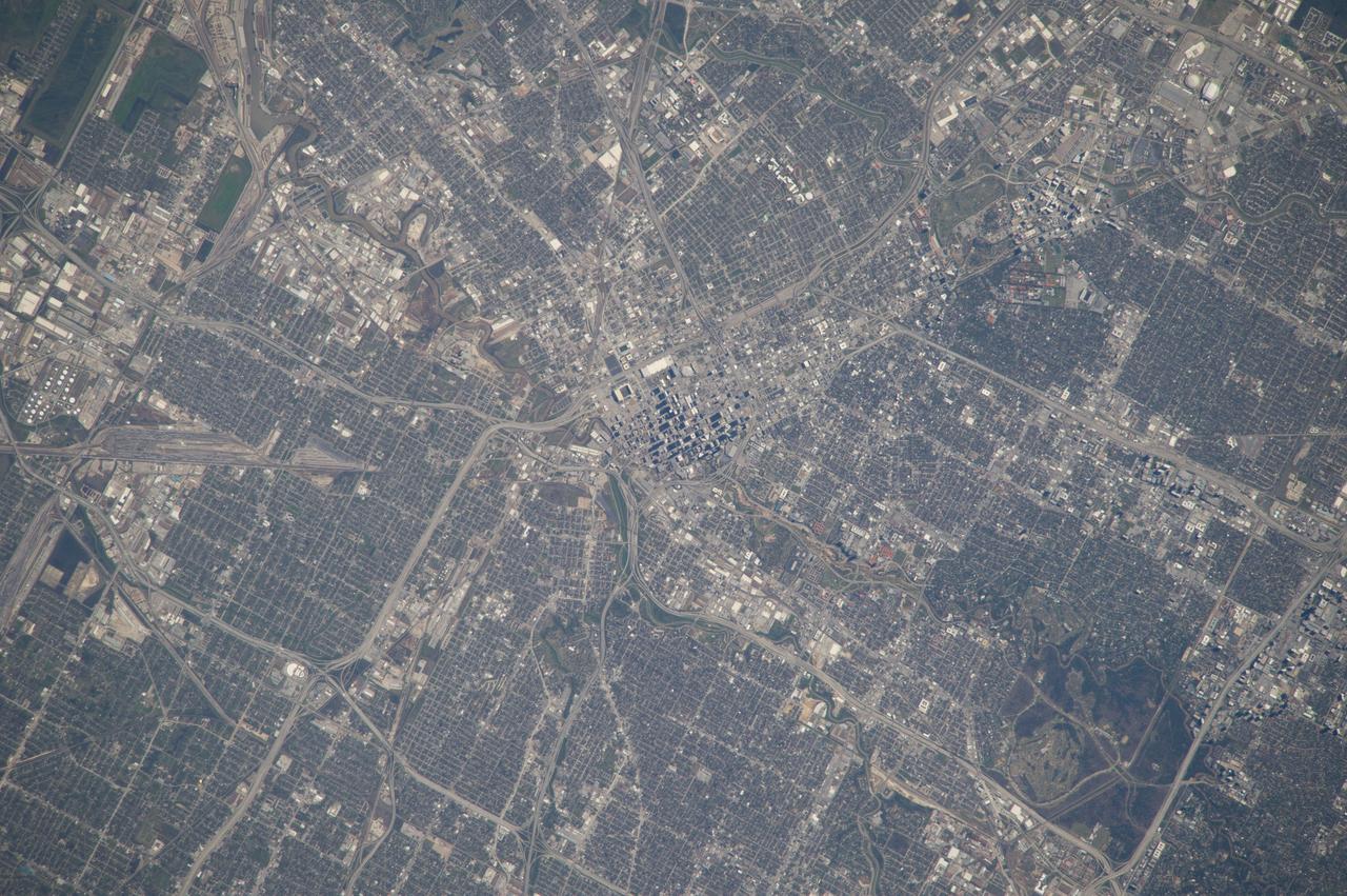 ISS039-E-000663 (12 March 2014) --- As in the case of this picture, when an astronaut in space uses an 800mm focal length, it is impossible to get the entire body of Houston, the nation's fourth most populous city, in one frame.  This photo was taken by one of the Expedition 39 crew members from the International Space Station on March 12, 2014.  The large lens and the clear spring like weather provide a better than usual aerial study of the city. The downtown business district is in the center of the frame. The Relaint Stadium complex, home to the Houston Livestock and Rodeo, currently in progress, can be seen in the upper right portion of the photo.