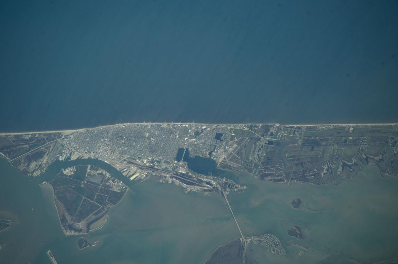 ISS039-E-000707 (12 March 2014) --- This nadir picture of Galveston Island and its coastline on the Gulf of Mexico was taken by one of the Expedition 39 crew members aboard the International Space Station on March 12. It was among the first batch of Earth photographs downlinked near the beginning of the Expedition 38 mission. The clear weather and the 800mm focal length used to record the photo allow for very detailed "bird's eye" viewing of the storied city. The Interstate 45 causeway can be seen at bottom center, and Scholes International Airport is seen nearby. The Bolivar Island ferry landing is just out of frame at bottom left.