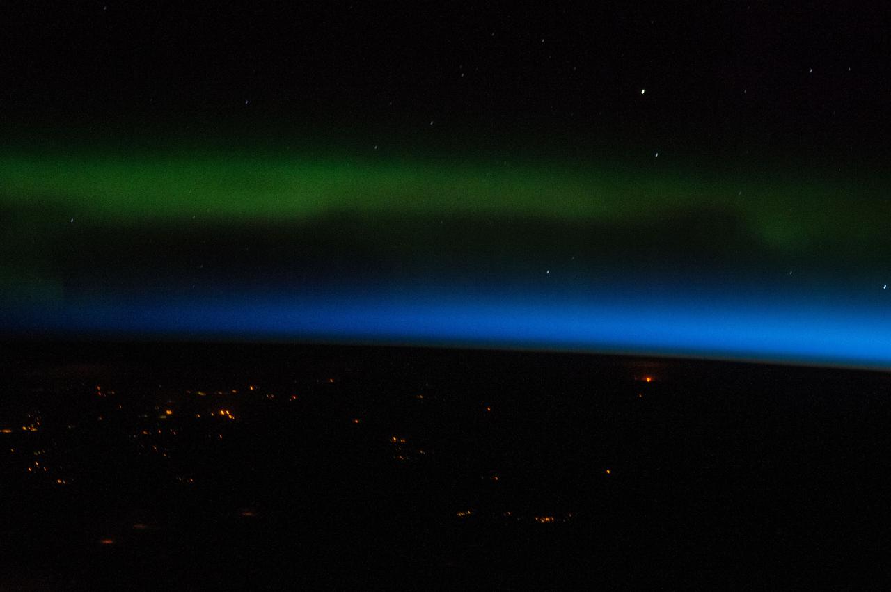 ISS039-E-005427 (25 March 2014) --- One of the Expedition 39 crew members aboard the International Space Station photographed this image while the outpost was over northeastern Kazakhstan. The crew member aimed the camera due  north or toward Russia, capturing the Aurora Borealis, which appears above the blue atmosphere.