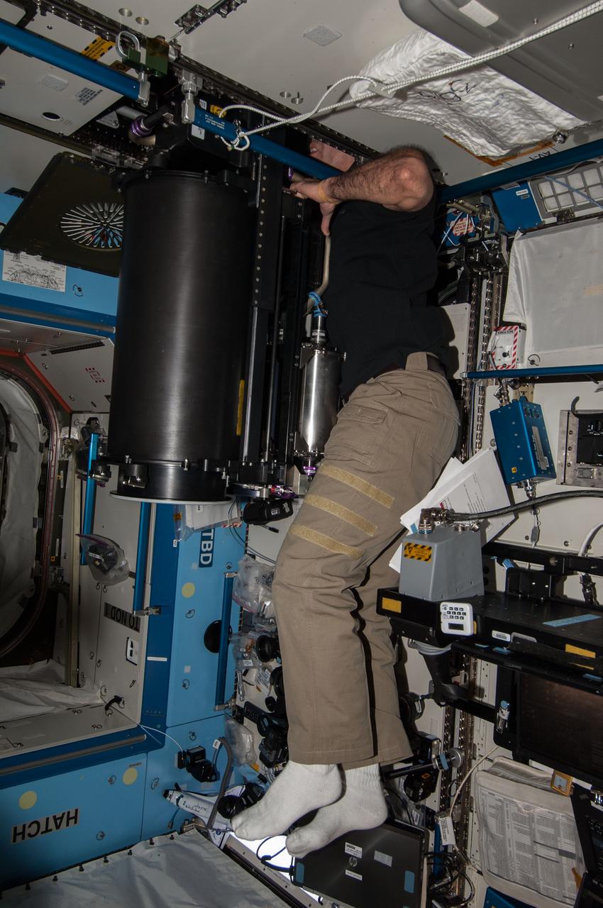 Expedition 39 flight engineer Rick Mastracchio looks for a loose connection as he conducts troubleshooting operations on the Carbon Dioxide Removal Assembly (CDRA) in the Destiny U.S. Laboratory. Image was released by astronaut on Twitter. (IO Note: Camera data file contains incorrect time.)