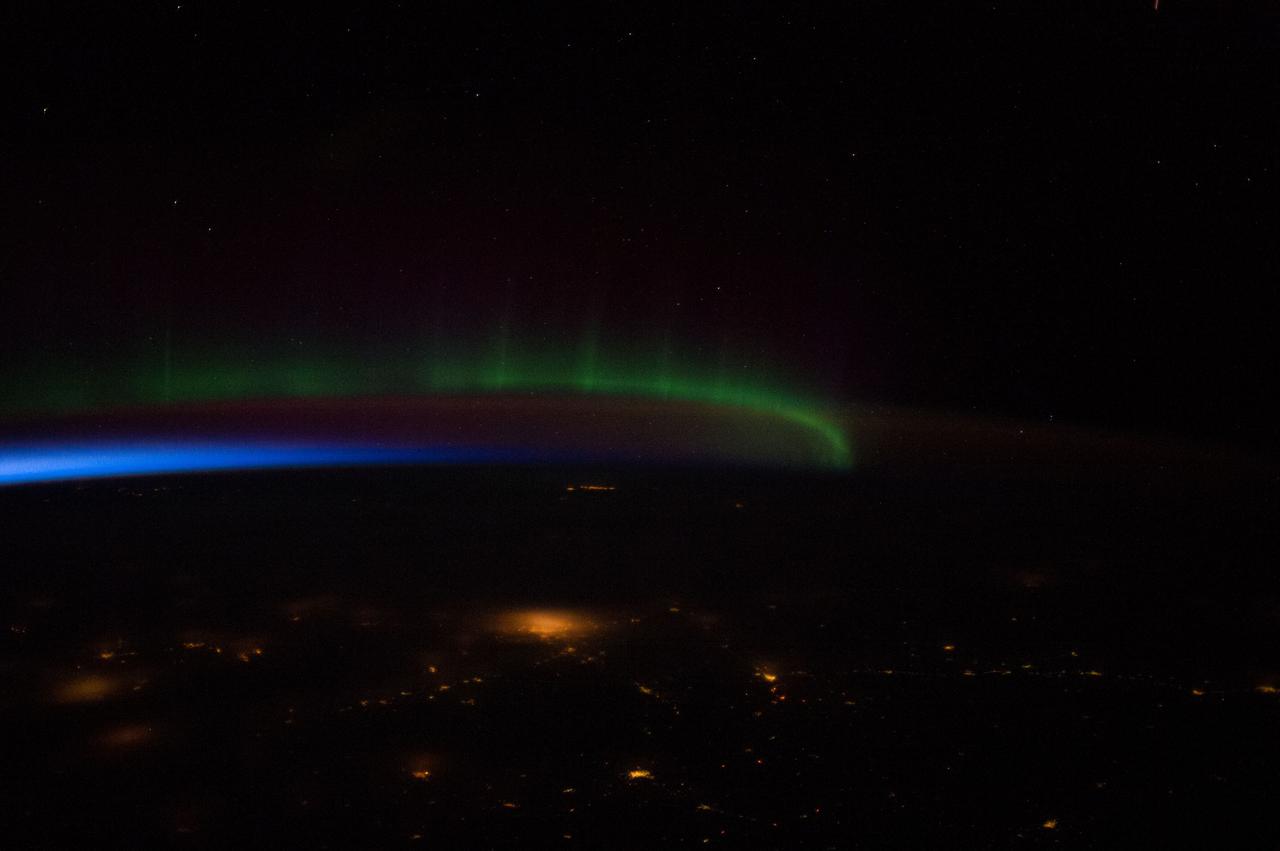 Earth observation taken by the Expedition 39 crew aboard the ISS. Night view of airglow, aurora, and city lights. Image was released by astronaut on Twitter and downlinked in folder: north lights.