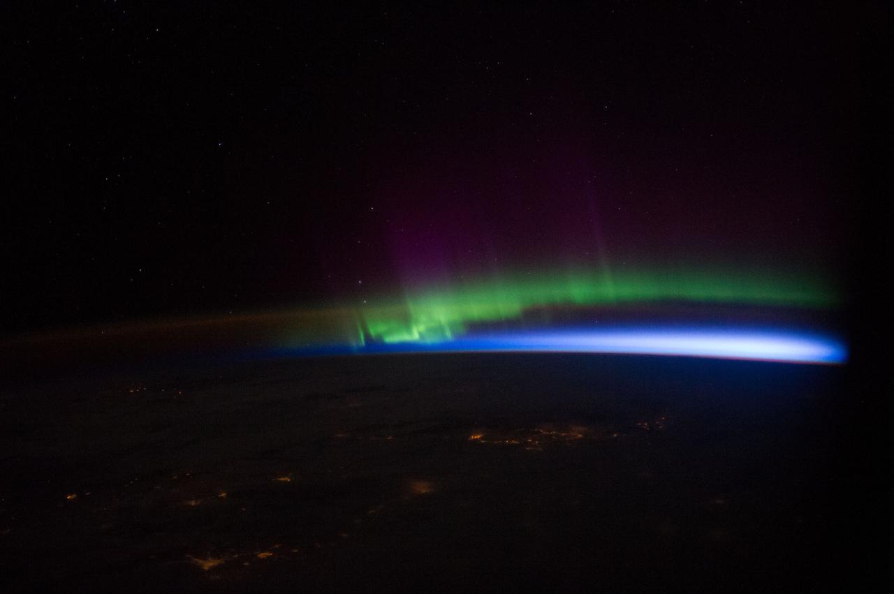 Earth observation taken by the Expedition 39 crew aboard the ISS. Night view of airglow, aurora, and city lights. Image was downlinked in folder: north lights, and released by flight engineer 3 (FE3) on Instagram.