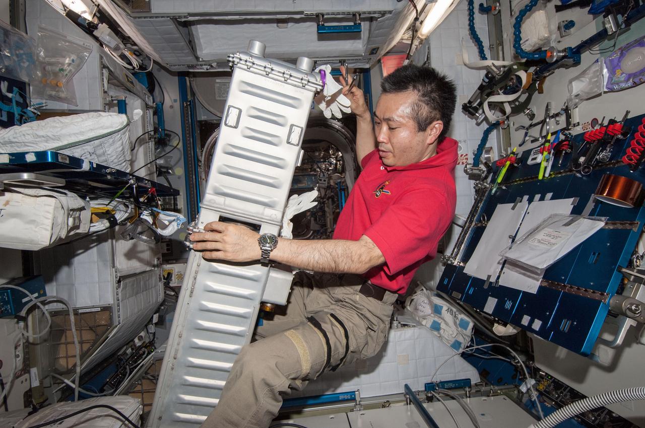 ISS039-E-0010321 (9 April 2014) --- Expedition 39 Commander Koichi Wakata of the Japan Aerospace Exploration Agency works in the Harmony node of the Earth-orbiting International Space Station performing maintenance on a Carbon Dioxide Removal Assembly (CDRA) Desiccant/Adsorbent Bed on April 9, 2014.