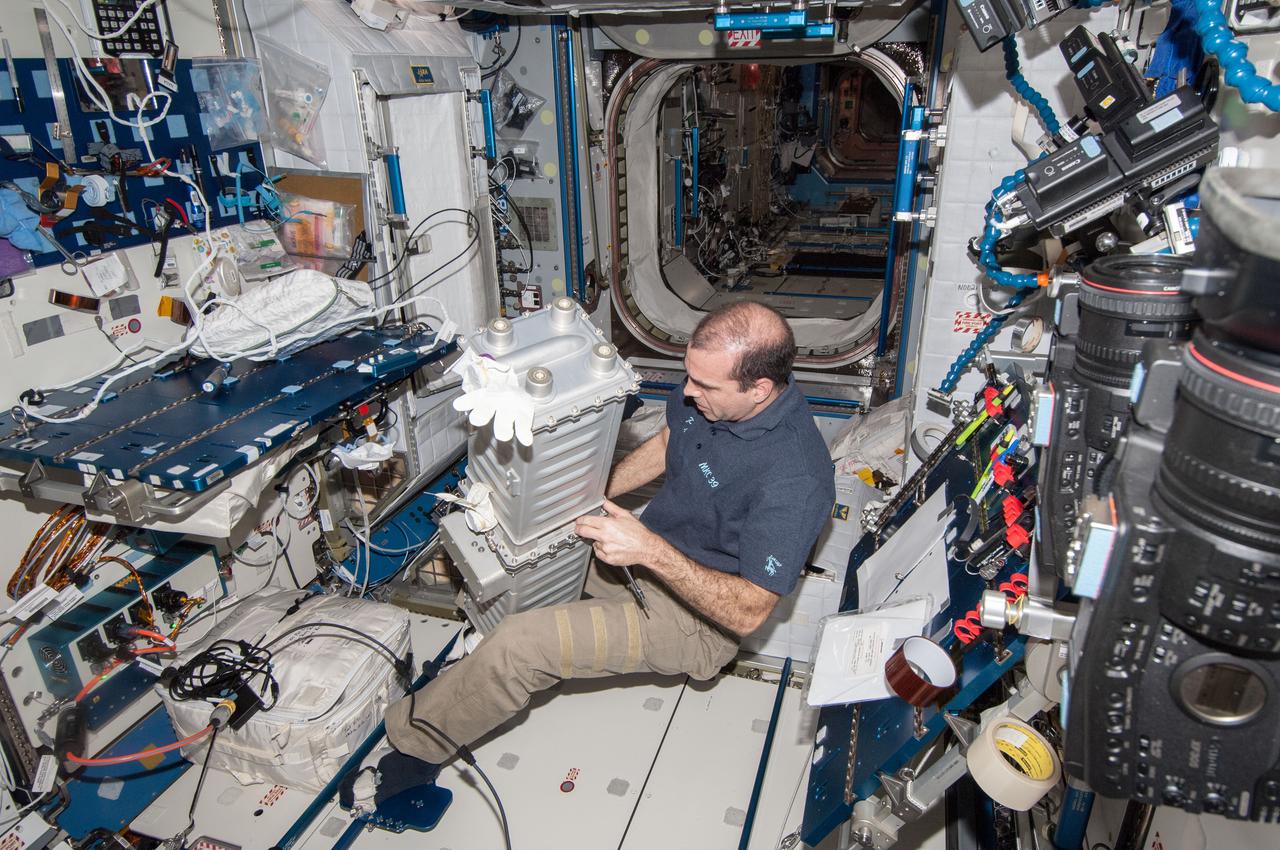 ISS039-E-010325 (9 April 2014) --- NASA astronaut Rick Mastracchio, Expedition 38/39 flight engineer, is seen in the Harmony node on the Earth-orbiting International Space Station performing maintenance on a Carbon Dioxide Removal Assembly (CDRA) Desiccant/Adsorbent Bed on April 9, 2014.
