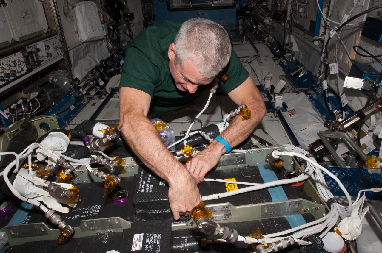 ISS039-E-010369 (9 April 2014) --- Expedition 39 Flight Engineer Steve Swanson of NASA works with the Carbon Dioxide Removal Assembly (CDRA) in the Kibo Laboratory aboard the International Space Station. For several days, the Expedition 39 crew members have been working with CDRA.