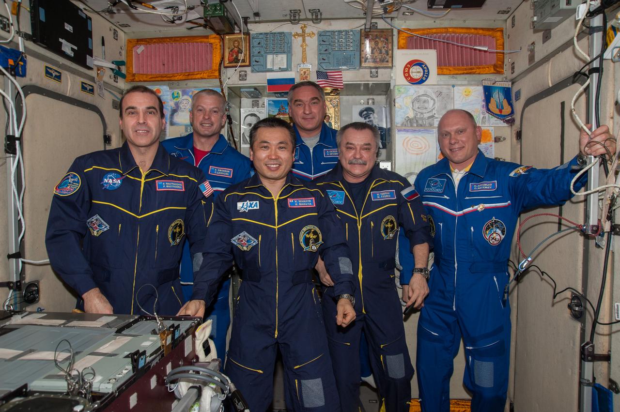 ISS039-E-011175 (11 April 2014) --- Inside the Zvezda service module on the Earth-orbiting International Space Station, the six Expedition 39 crew members face the camera during a call with Russian President Vladimir Putin. From left to right are NASA astronauts Rick Mastracchio and Steve Swanson, both flight engineers; Commander Koichi Wakata of the Japan Aerospace Exploration Agency (JAXA), and cosmonauts Alexander Skvortsov, Mikhail Tyurin and Oleg Artemyev, all flight engineers with Russia's Federal Space Agency (Roscosmos).